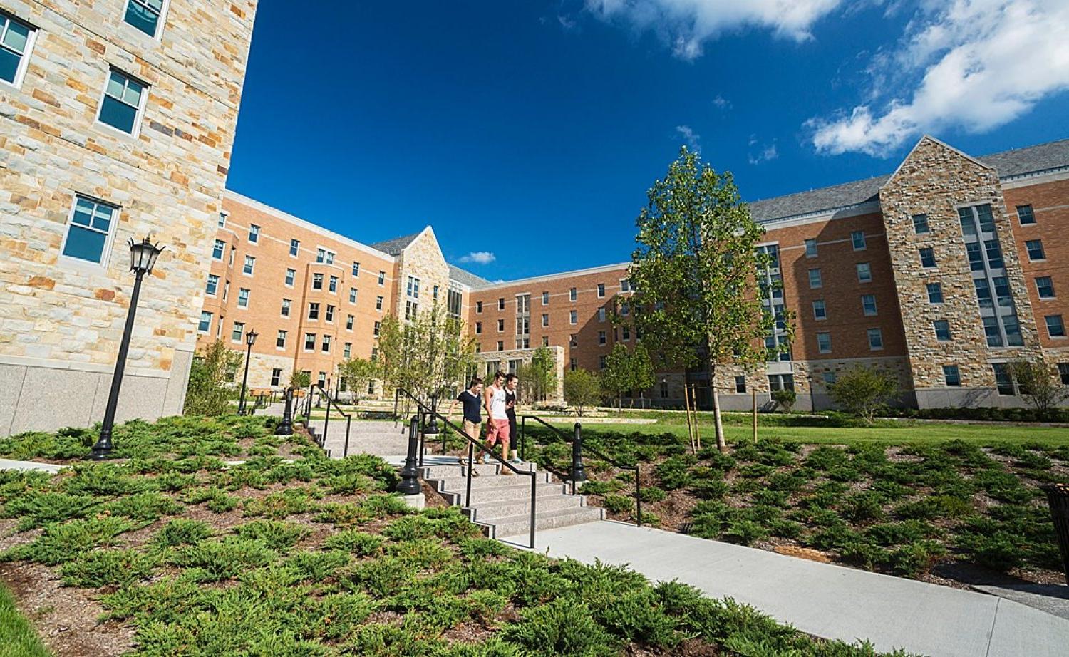 students walking out of the new St. Thomas More Apartments